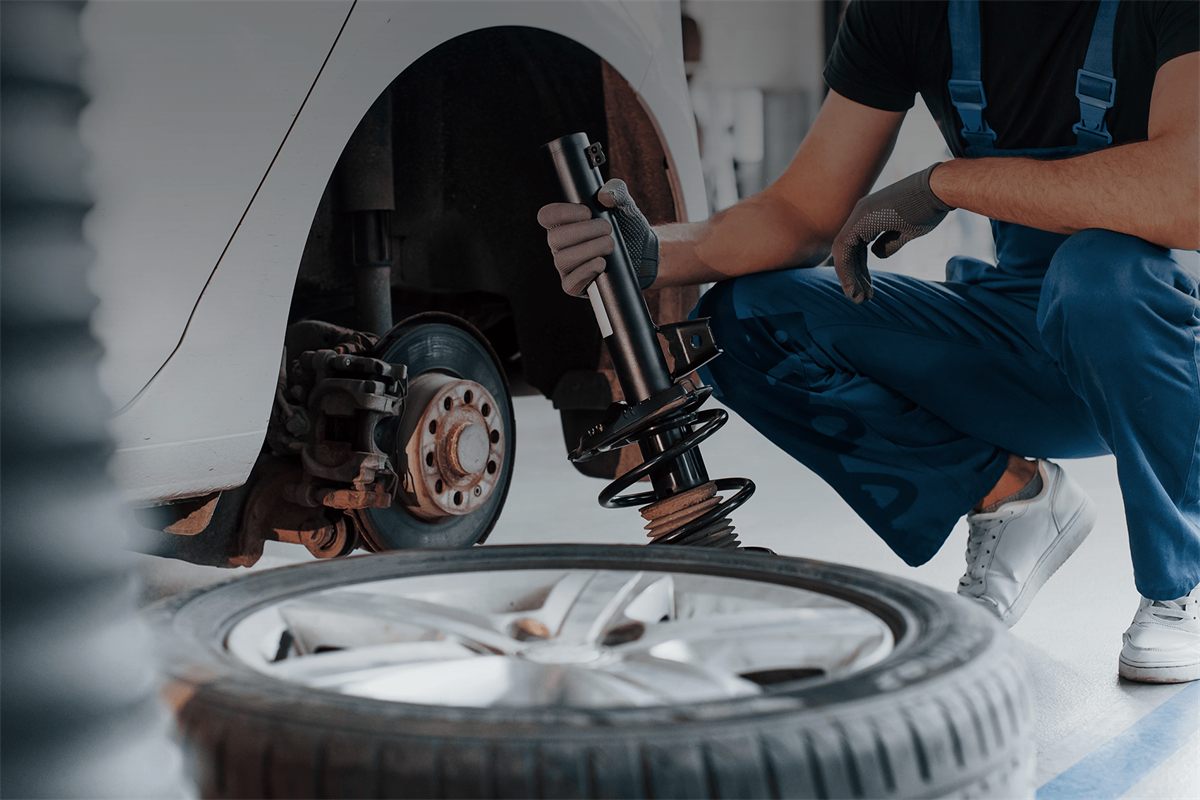 Technician installing a suspension strut