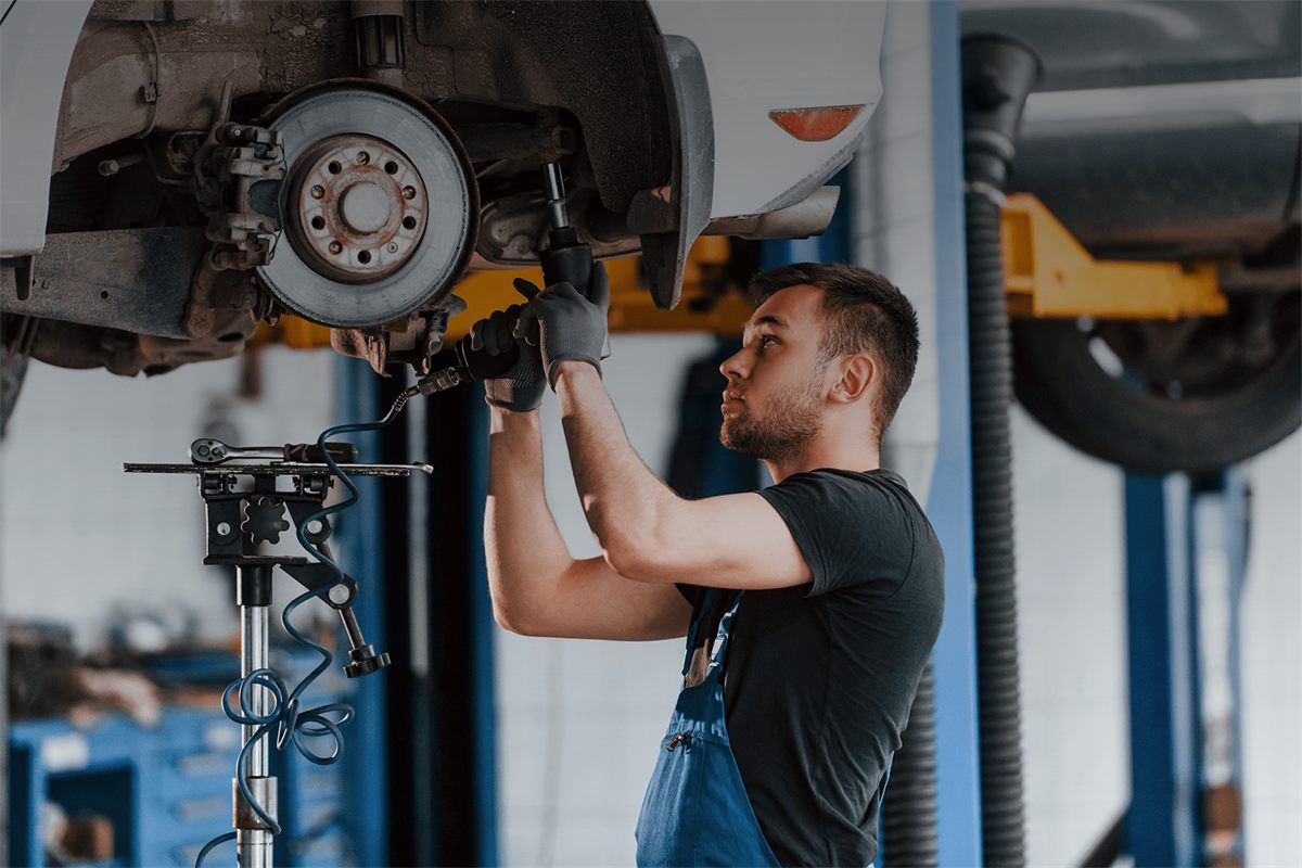 Technician working on a vehicle suspension